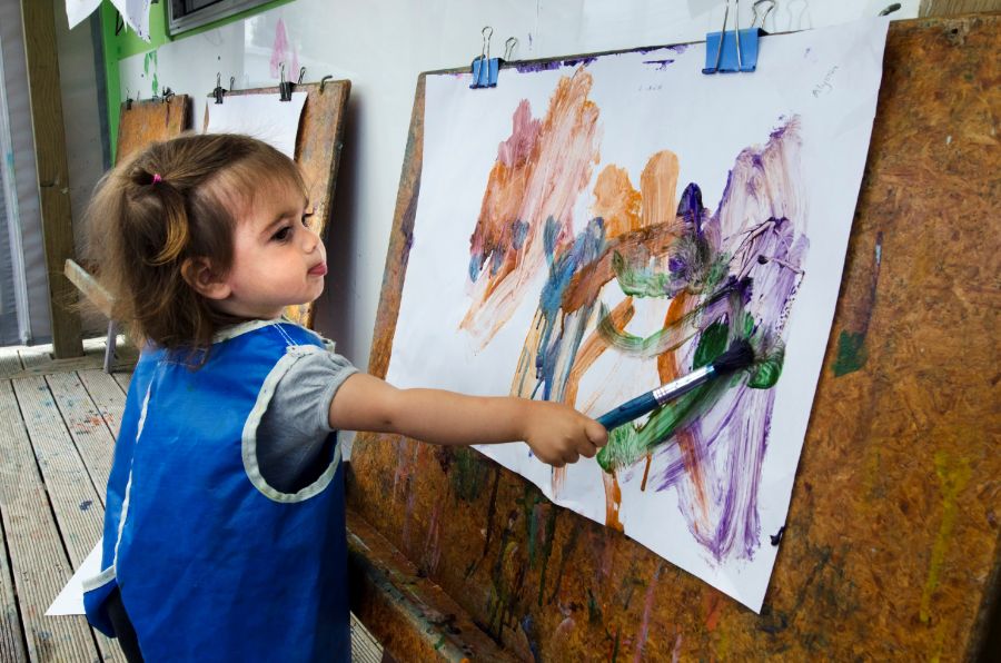Child painting at a early childhood education centre built by Advance Build