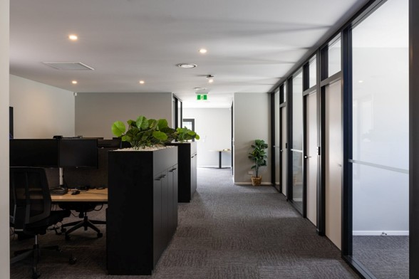 Open-plan commercial office interior with workstations and glazed meeting rooms in a factory-built Advance Build building