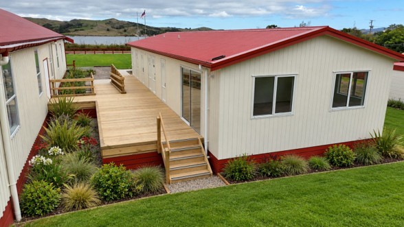 Factory-built ablution block with timber deck and landscaped gardens at Otamatea Marae, overlooking the harbour